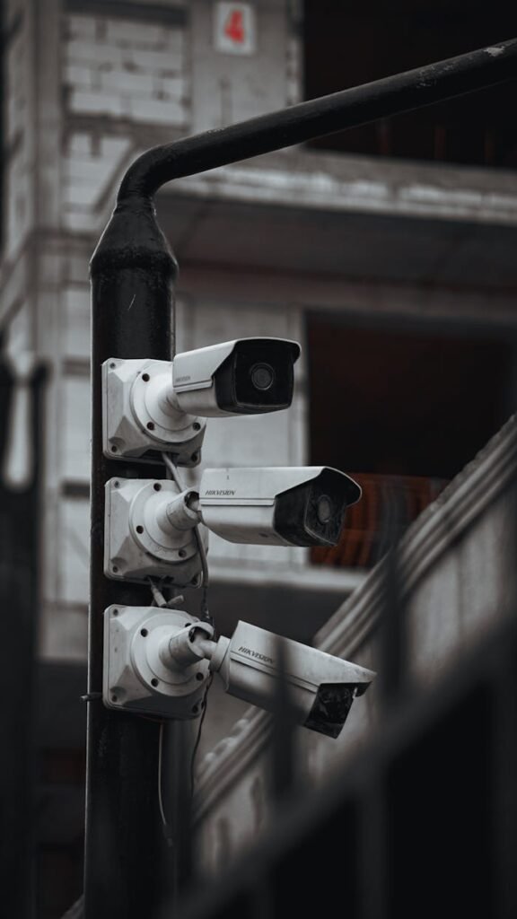 Array of security cameras on a building post, highlighting surveillance and urban security.